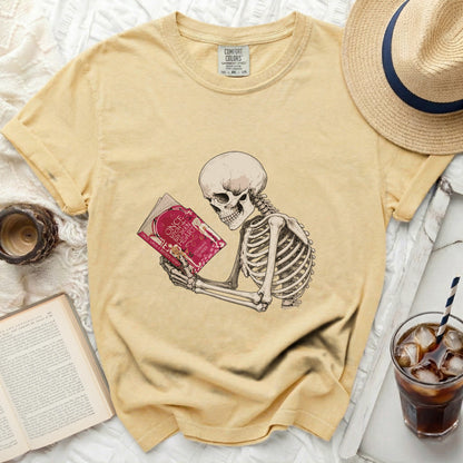 Skeleton reading "Once Upon a Broken Heart" on a yellow t-shirt.