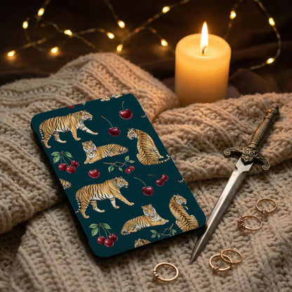 Case with tigers and cherries, next to a candle and dagger.