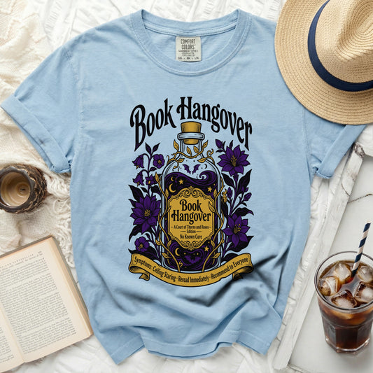 Light blue t-shirt with "Book Hangover" graphic and book theme.