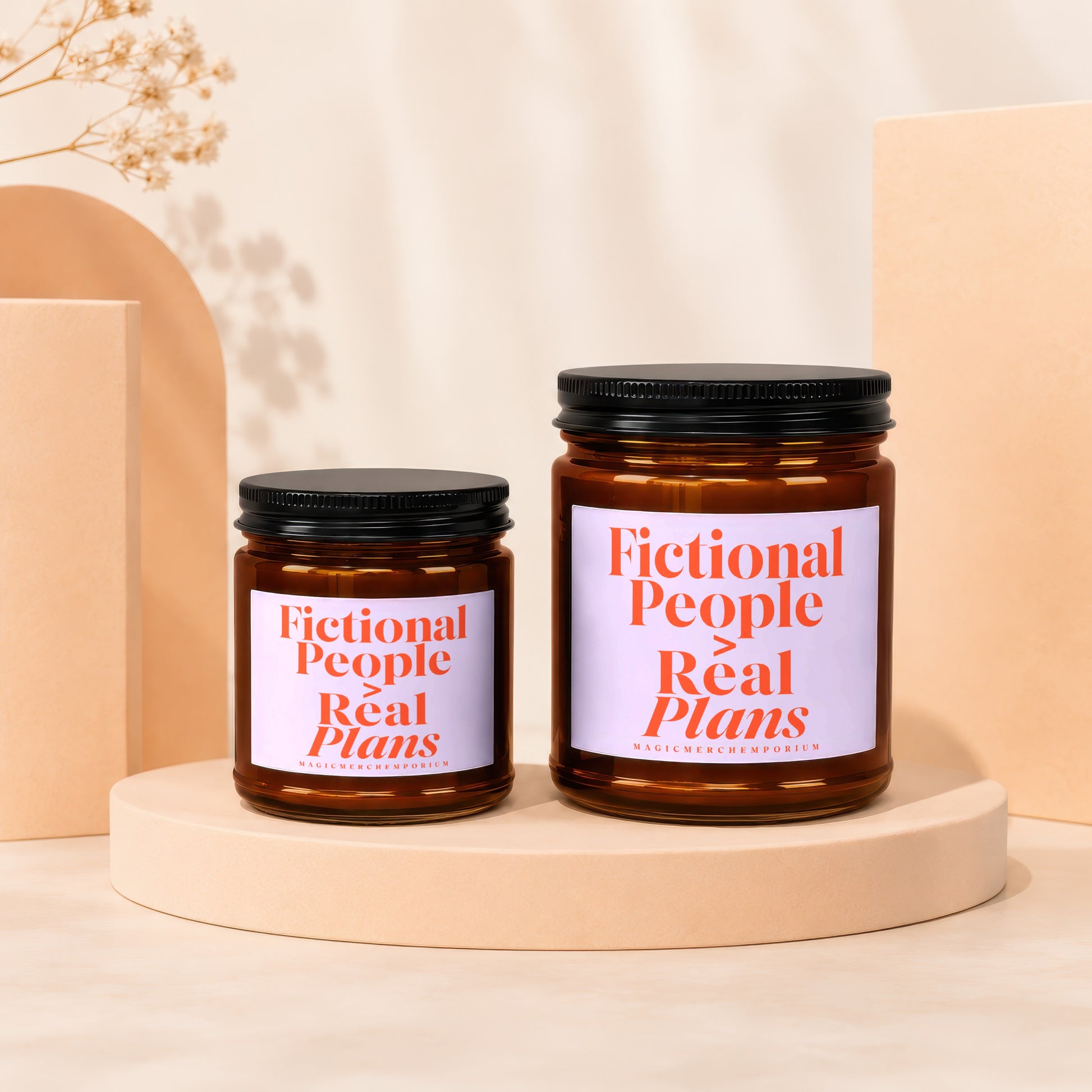 Two amber glass candles with black lids, labeled "Fictional People Real Plans".