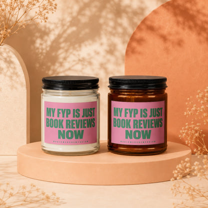 Two candles with pink labels reading "MY FYP IS JUST BOOK REVIEWS NOW".