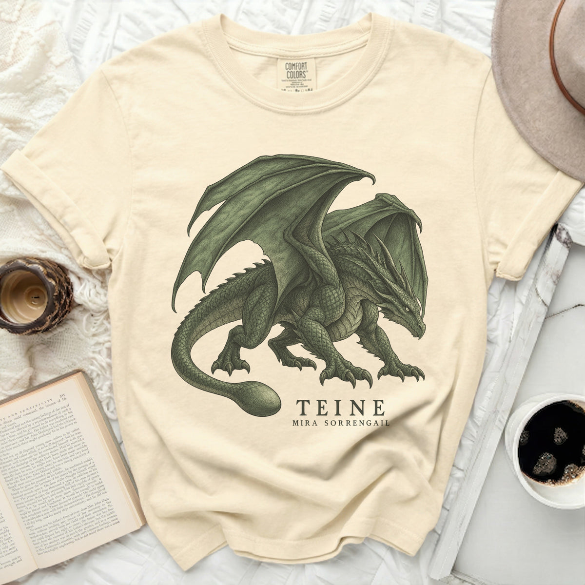 Cream t-shirt with a green dragon graphic and text "TEINE MIRA SORRENGAIL".