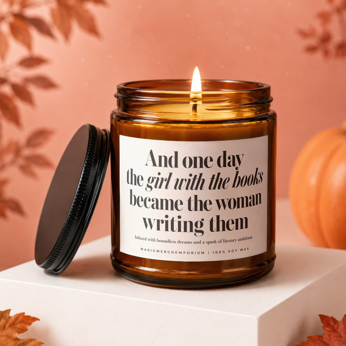 Amber candle with text "The girl with the books became the woman writing them."