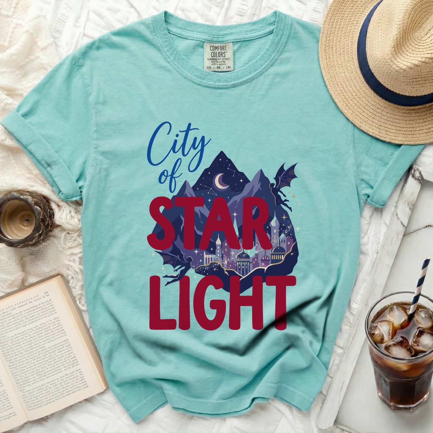 Teal t-shirt with "City of Star Light" graphic and dragon silhouette.