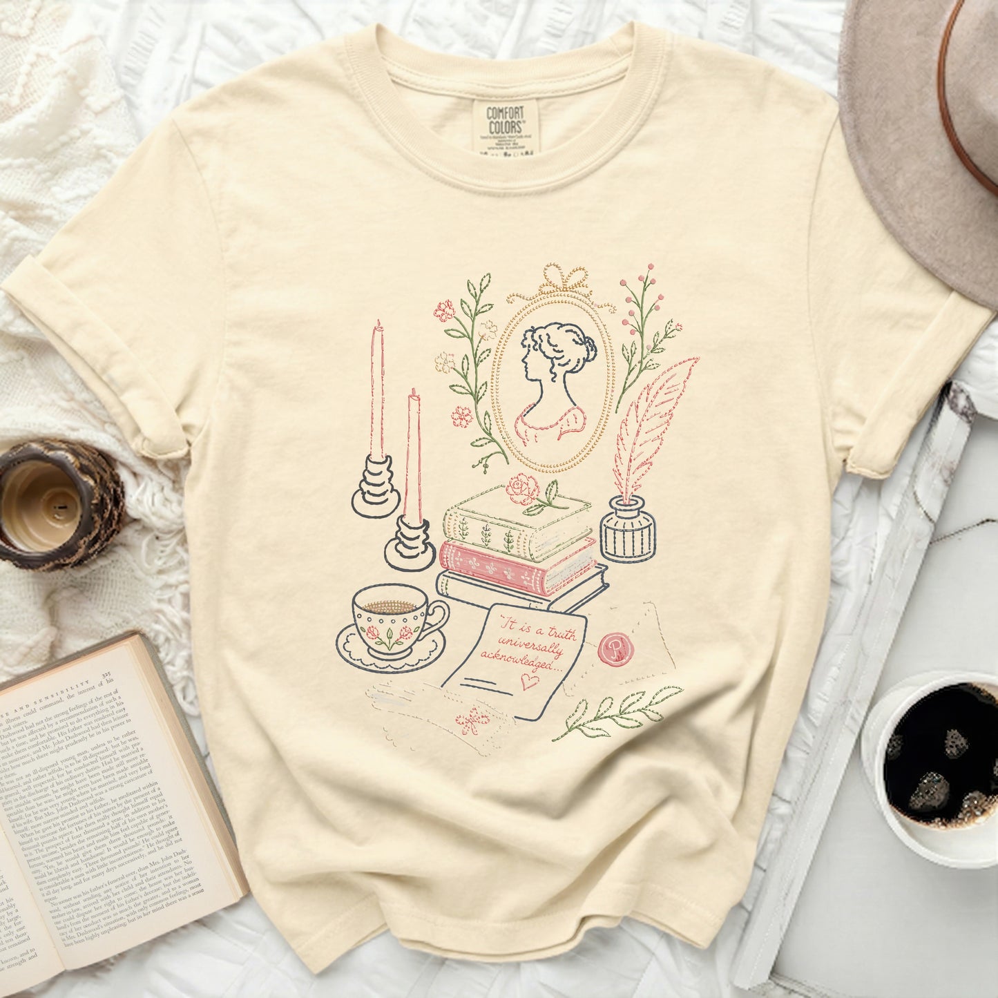T-shirt with embroidered vintage scene: silhouette, books, teacup, quill, candles.