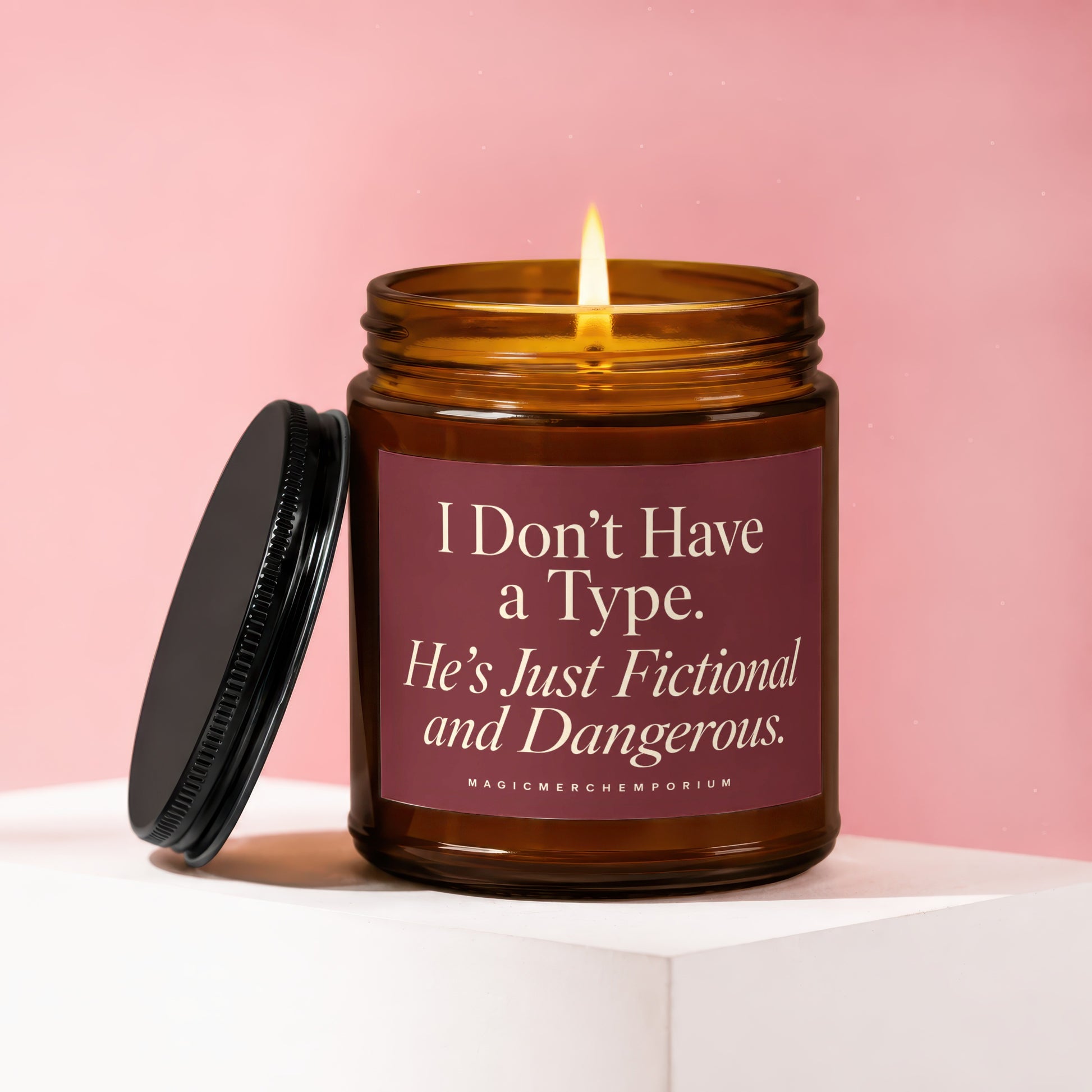 Amber glass candle burning with "I Don't Have a Type. He's Just Fictional and Dangerous." text.