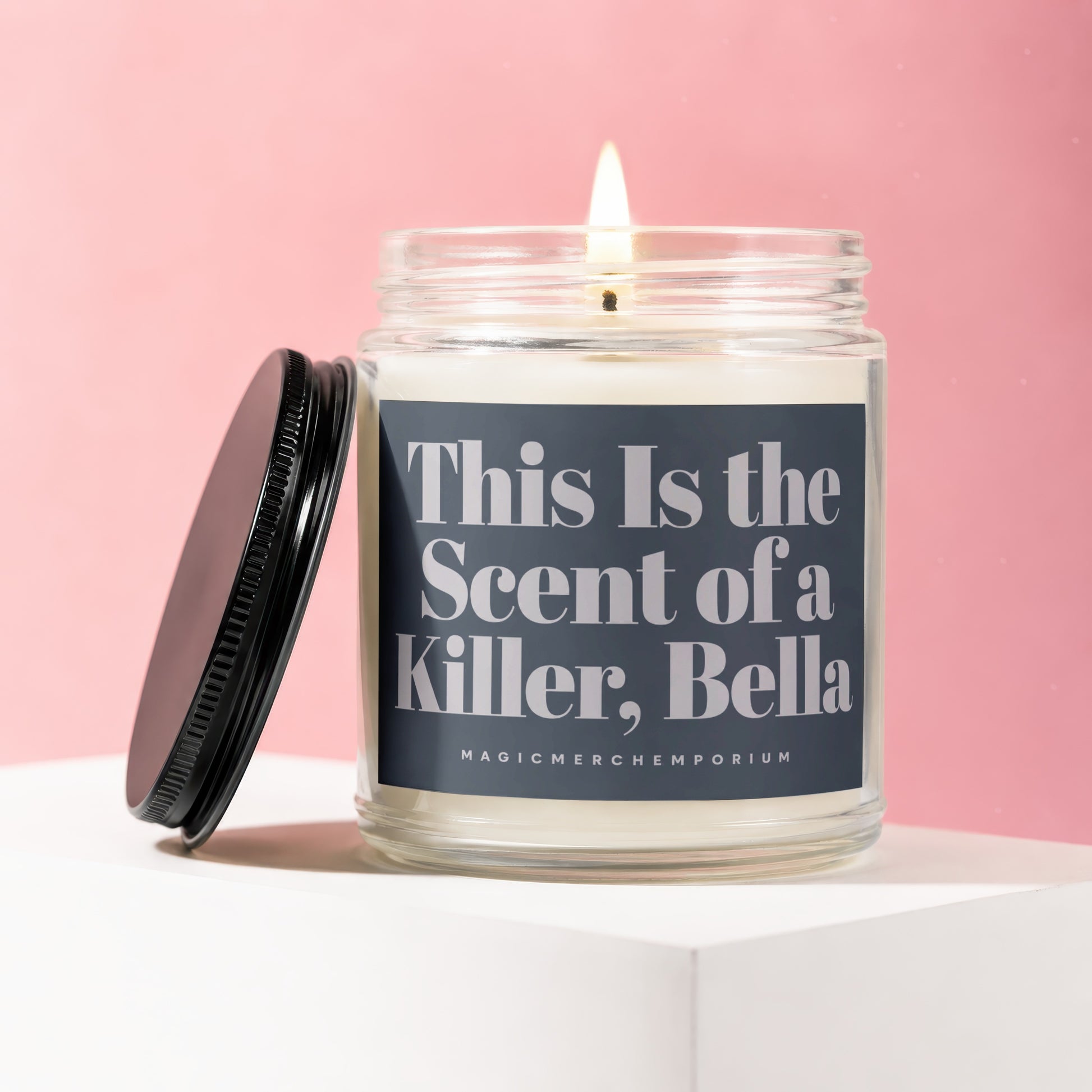 Candle with label "This Is the Scent of a Killer, Bella" and MagicMerch Emporium logo.