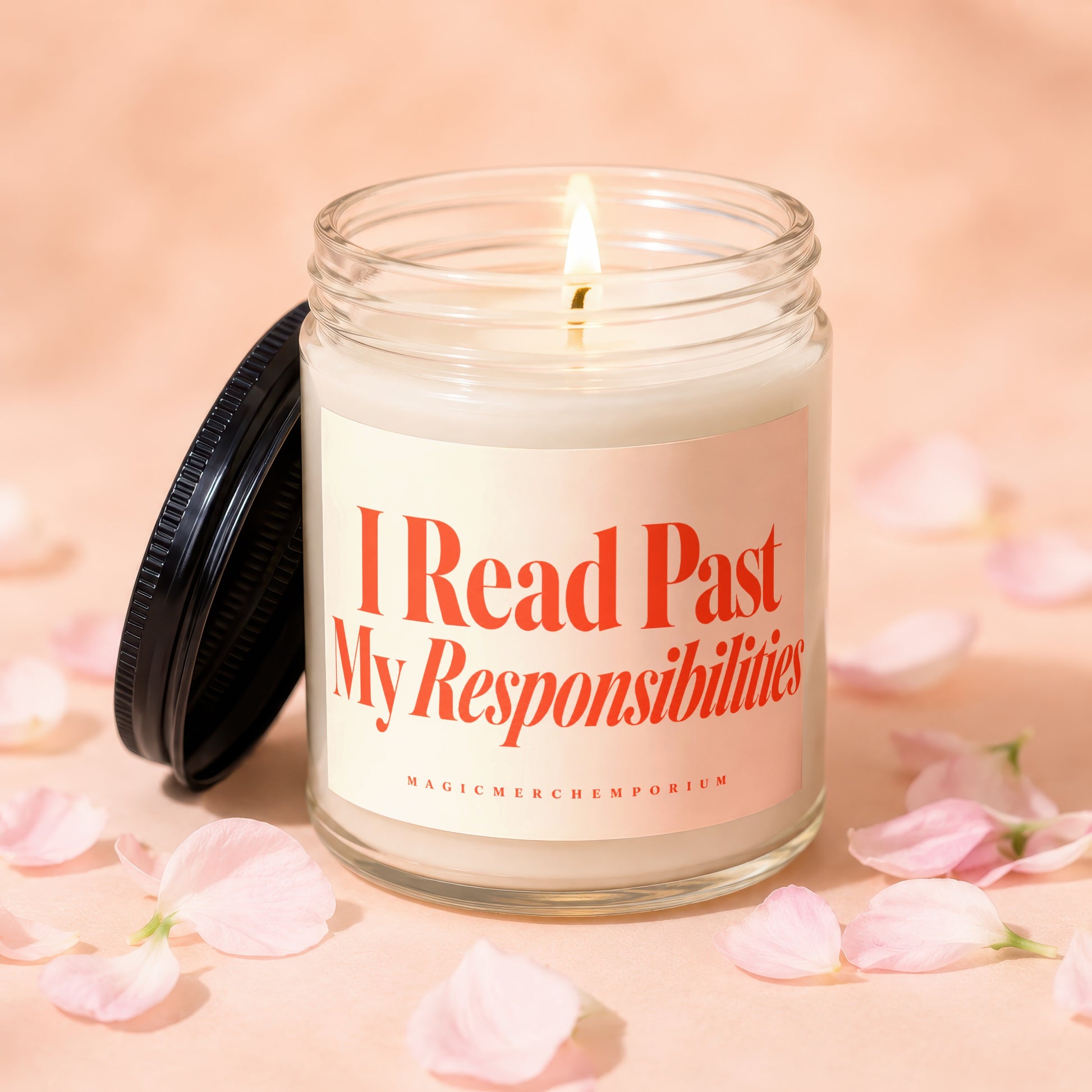 Lit candle in glass jar with label reading "I Read Past My Responsibilities."