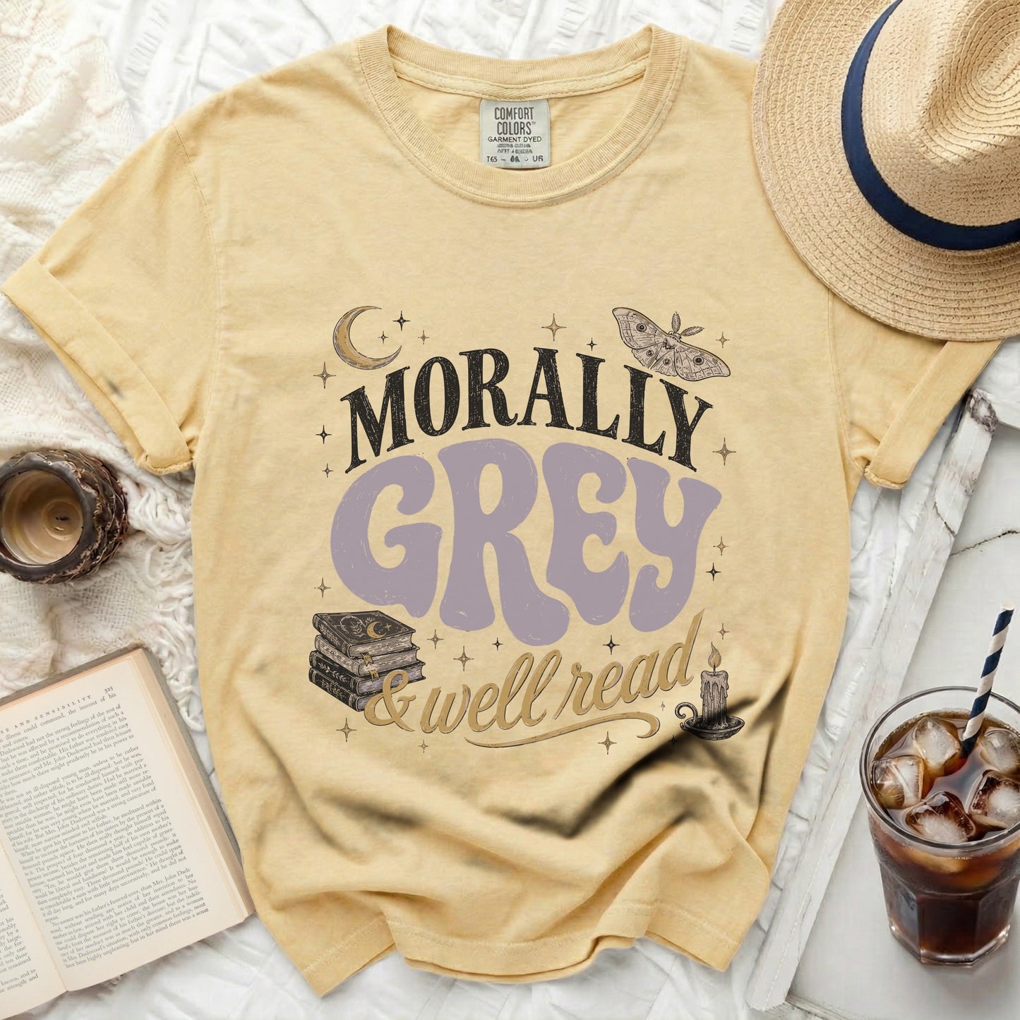 Yellow Comfort Colors t-shirt with "Morally Grey & Well Read" text and illustrations.