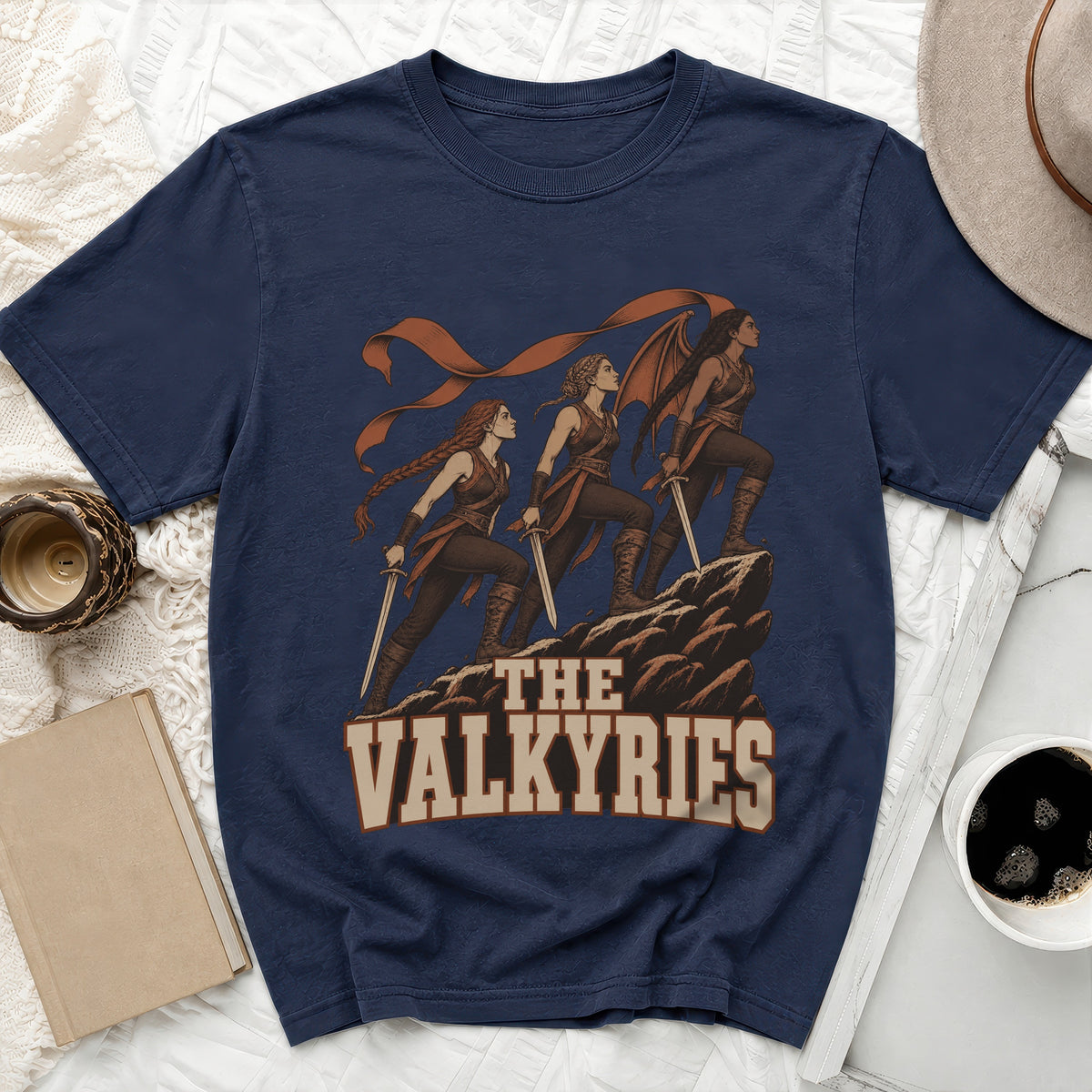 Navy t-shirt with graphic of three Valkyries on a rocky outcrop with "THE VALKYRIES" text.