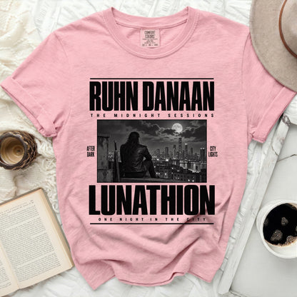 Pink t-shirt with "RUHN DANAAN LUNATHION" graphic and city skyline.