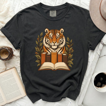 T-shirt featuring a tiger surrounded by books and foliage, "Comfort Colors" label visible.
