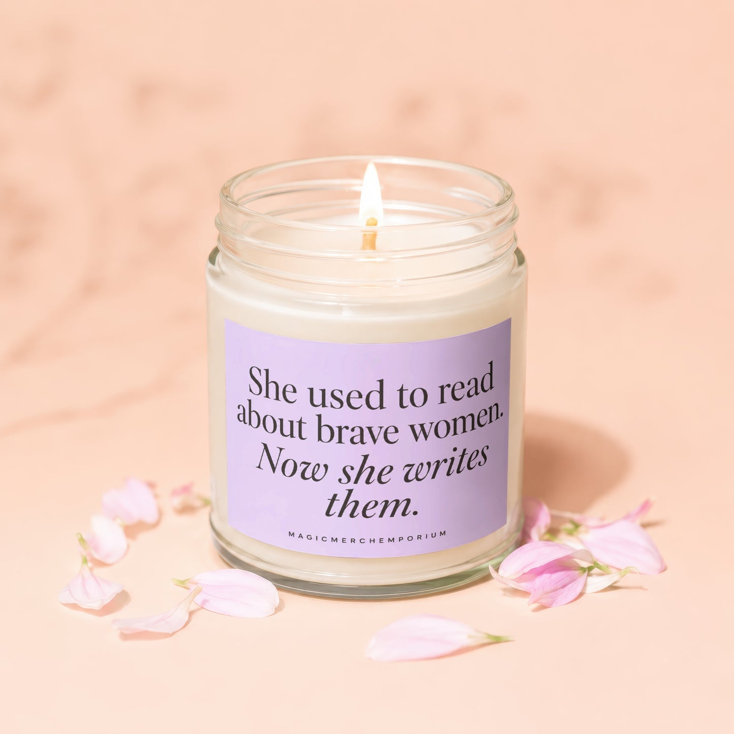 Candle with text "She used to read about brave women. Now she writes them."