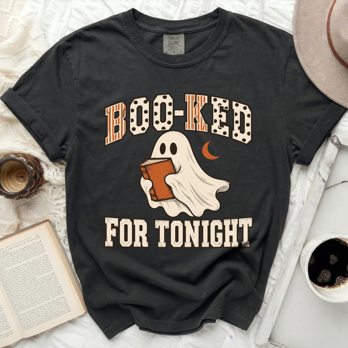 Dark t-shirt with "Boo-ked for Tonight" text and ghost reading a book.
