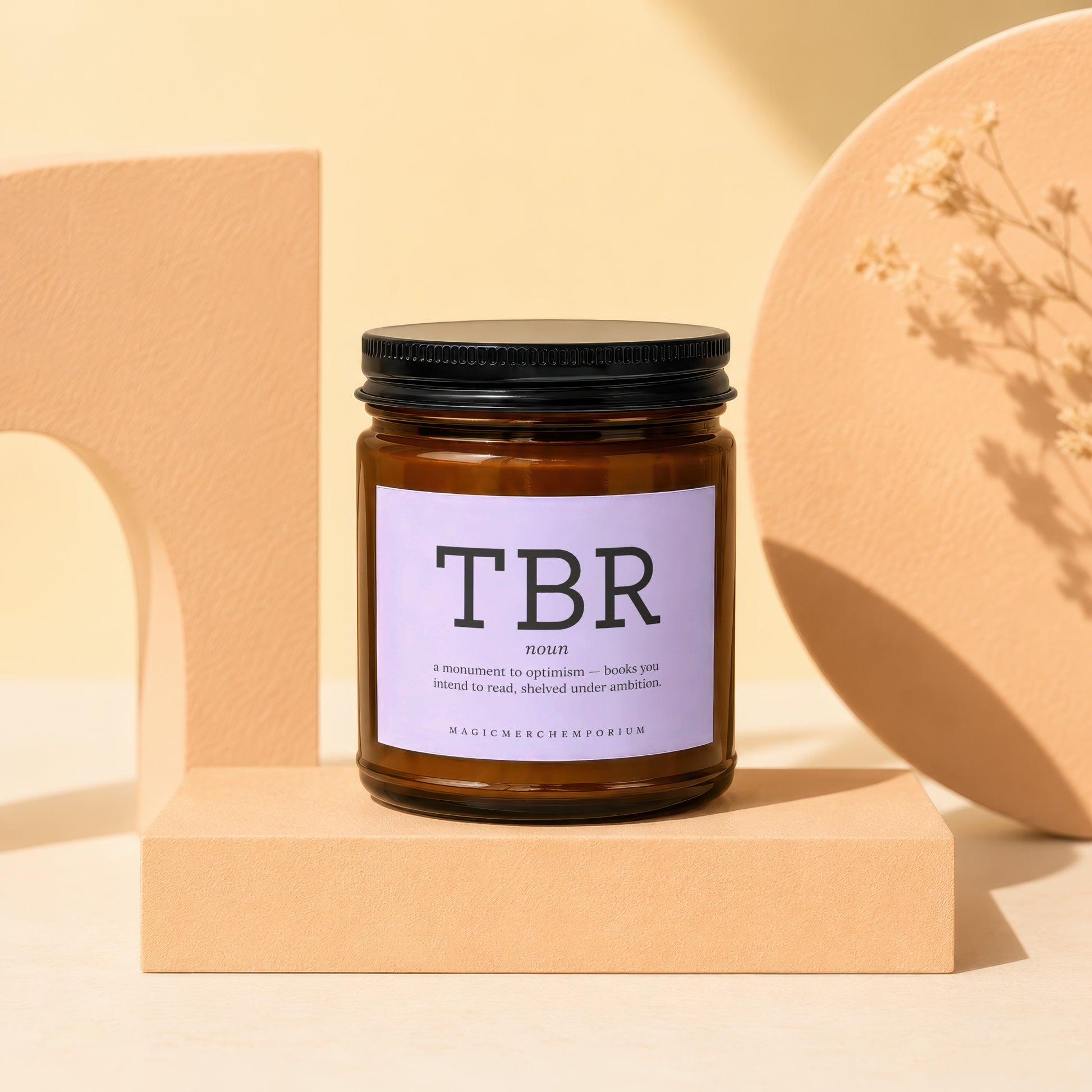 Amber jar candle with black lid, "TBR" label, definition of TBR, and brand name.