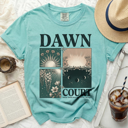 Teal t-shirt with four panels: sunbursts, flowers, moon phases, and text.