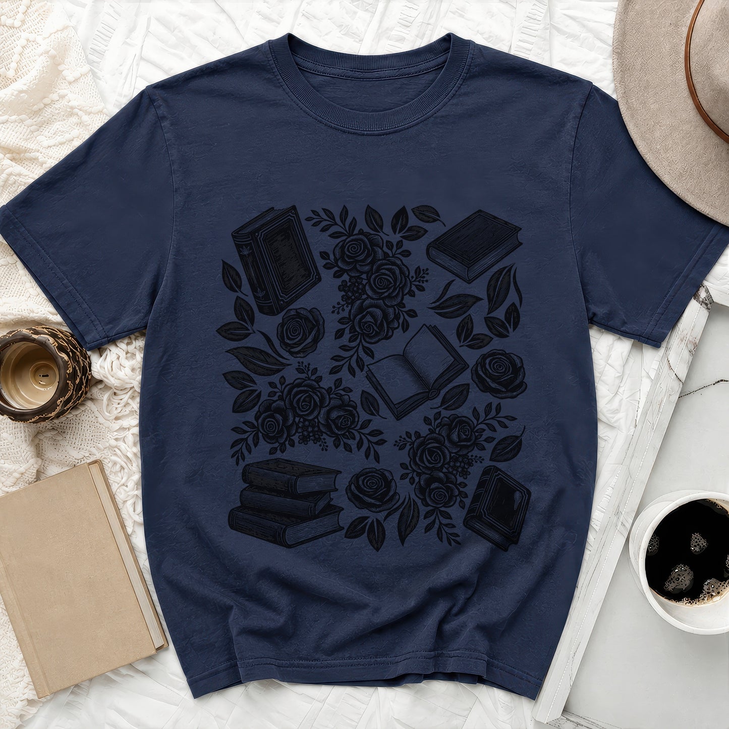 Navy t-shirt with black sketched books and roses pattern.