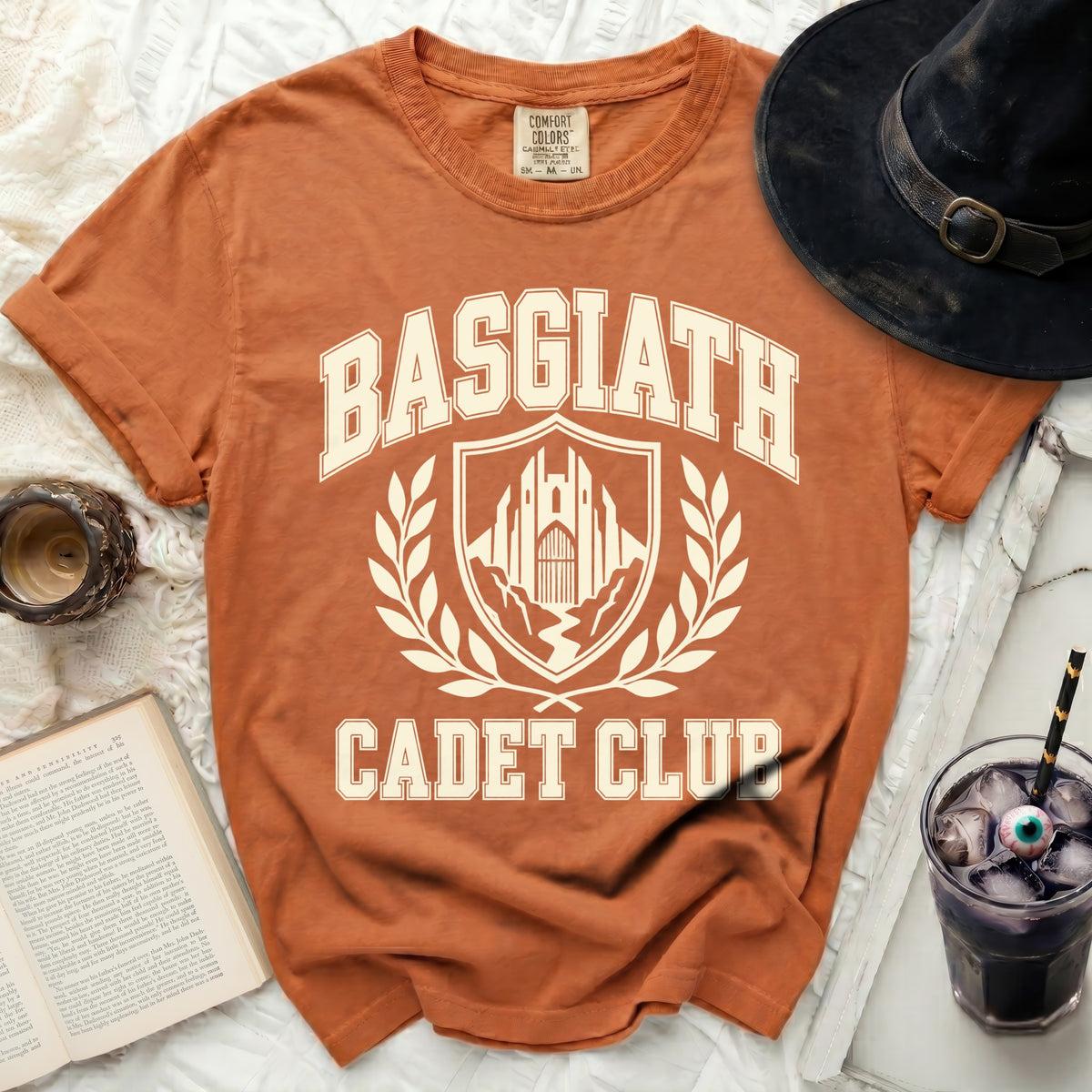 Orange t-shirt with "BASGIATH CADET CLUB" text and a crest graphic.
