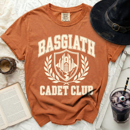 Orange t-shirt with "BASGIATH CADET CLUB" text and a crest graphic.