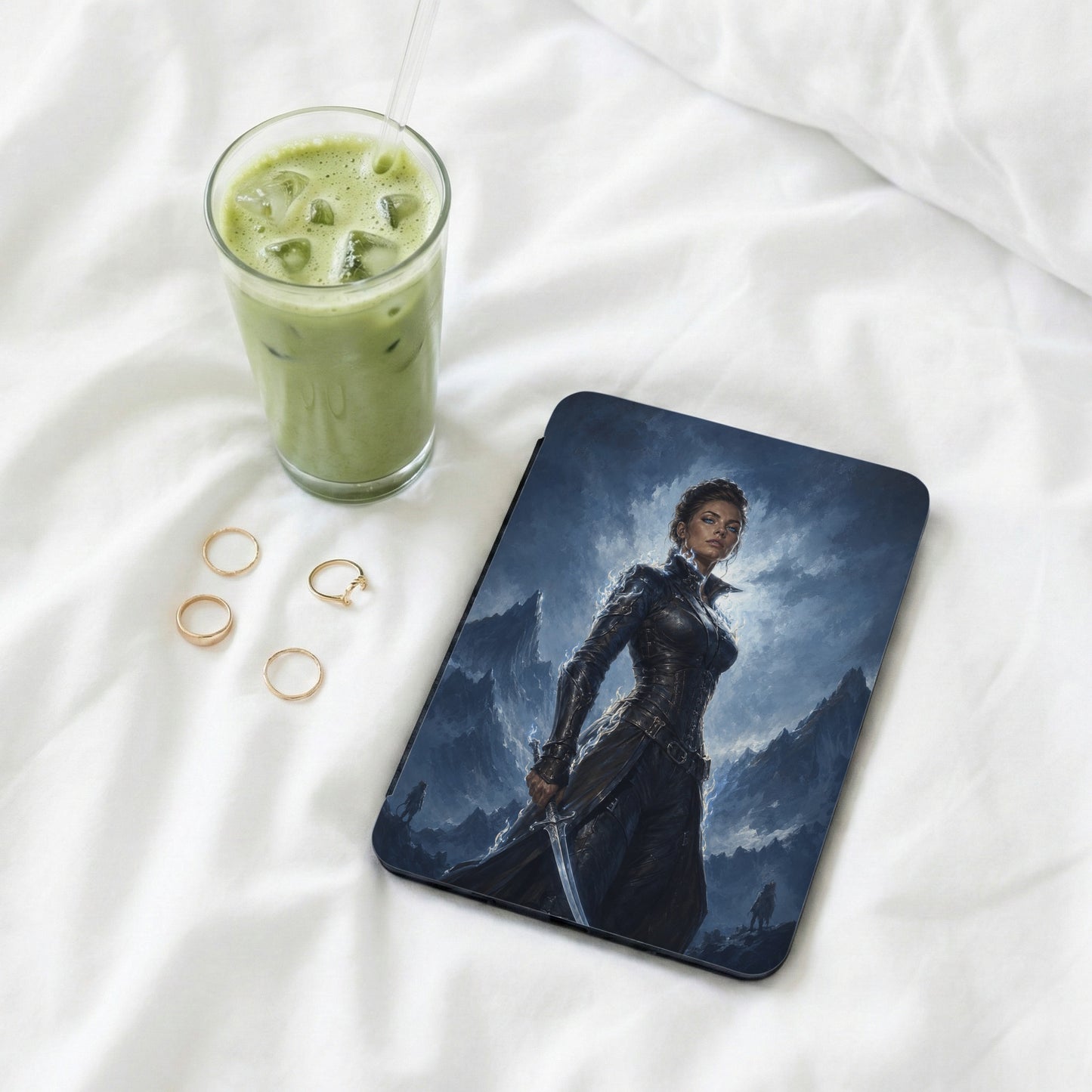 Tablet case with fantasy warrior on a mountain landscape with iced drink and rings.