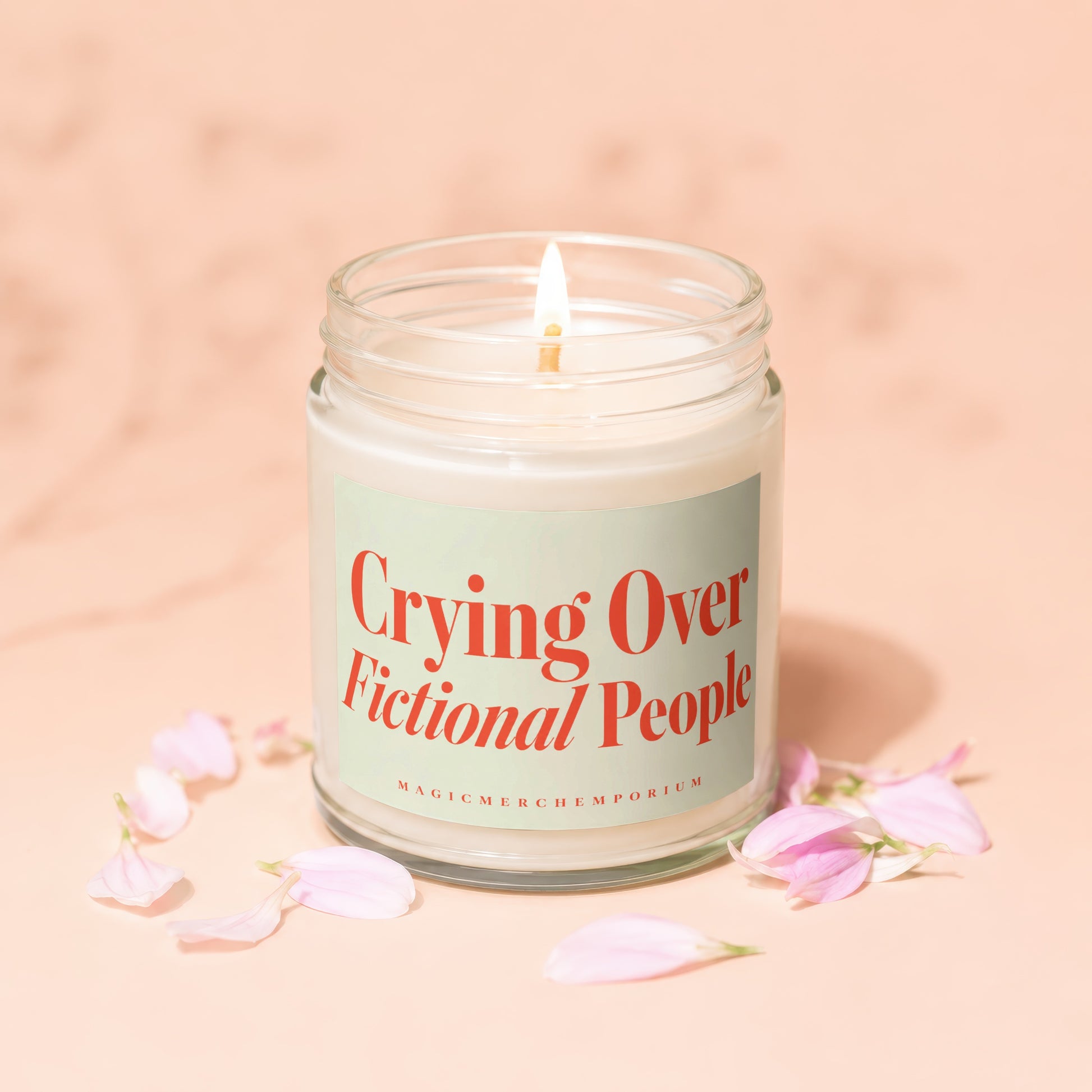 Candle with lit wick and label reading "Crying Over Fictional People".