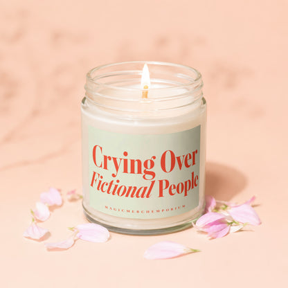 Candle with lit wick and label reading "Crying Over Fictional People".