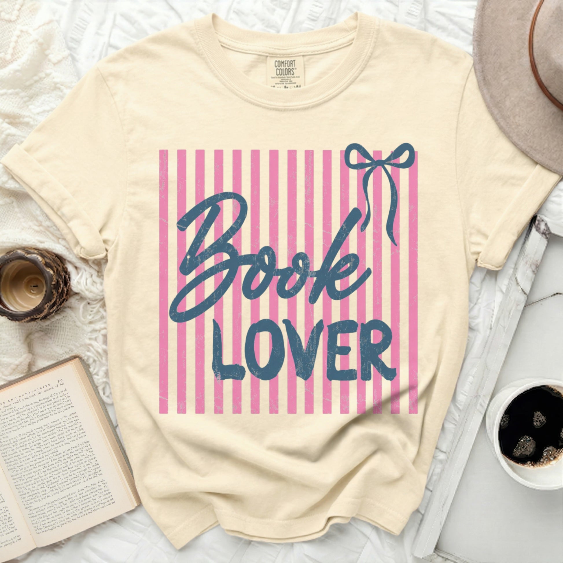 Cream t-shirt with pink stripes and "Book Lover" graphic.