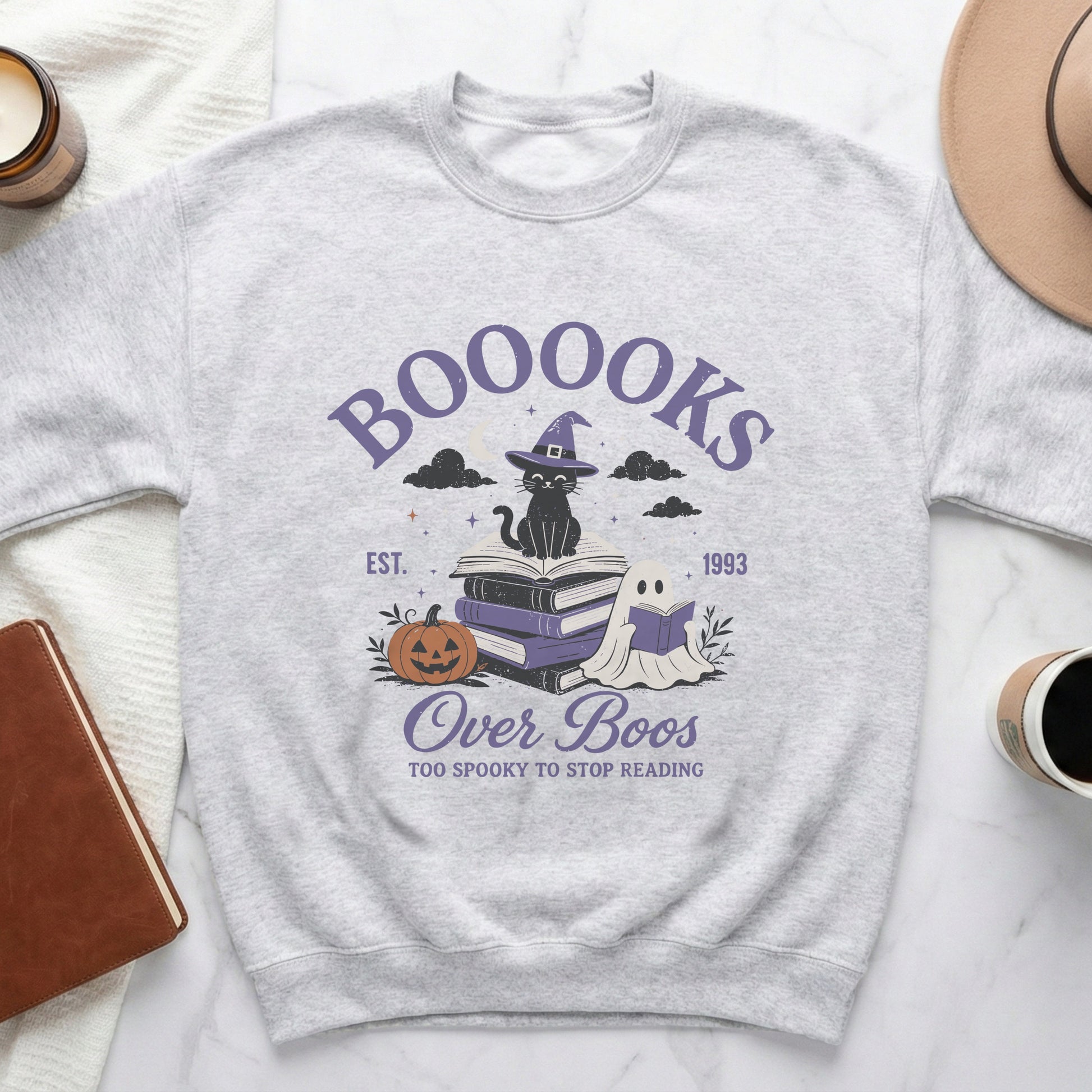 Grey sweatshirt with "Boooooks Over Boos" graphic featuring a black cat, books, ghost, and pumpkin.