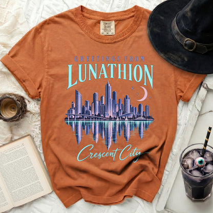 Orange t-shirt with "Greetings from Lunathion Crescent City" text and a skyline graphic.