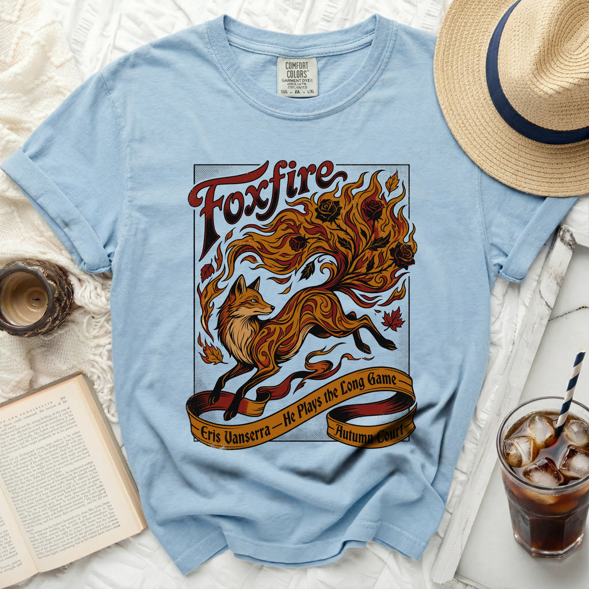 Light blue t-shirt with "Foxfire" and a flaming fox design, Eris Vanserra.