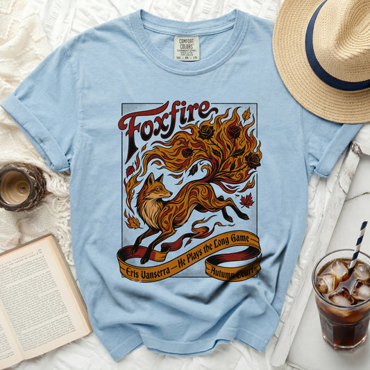 Light blue t-shirt with "Foxfire" and a flaming fox design, Eris Vanserra.