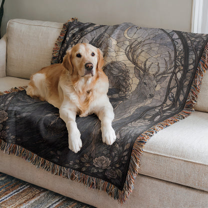 A golden retriever dog is lying on a couch, resting on a decorative blanket with a floral pattern.