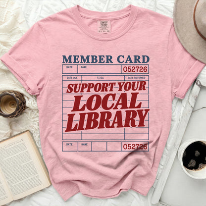 Pink t-shirt with "MEMBER CARD" and "SUPPORT YOUR LOCAL LIBRARY" text.
