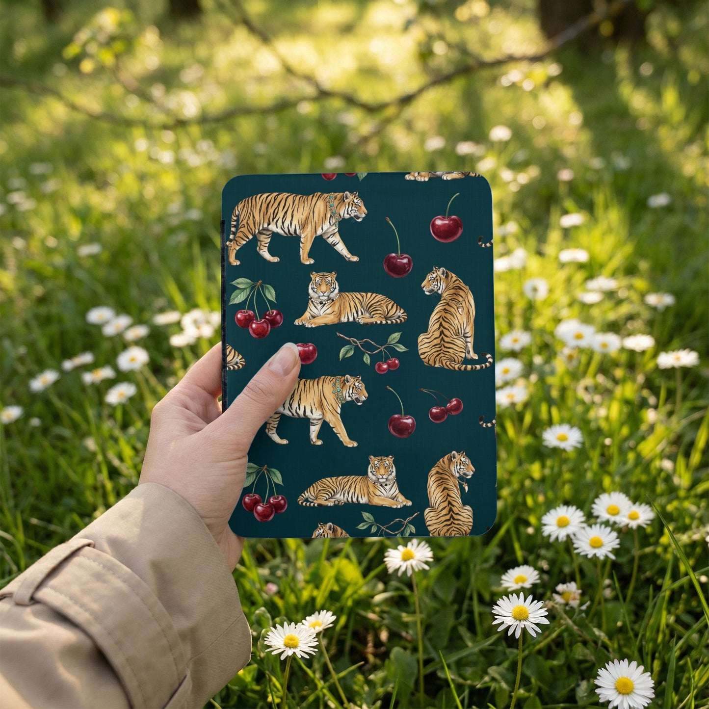 Dark green pattern with tigers and cherries held by a hand in a garden.
