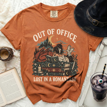 Orange t-shirt with "OUT OF OFFICE LOST IN A ROMANTASY" graphic.