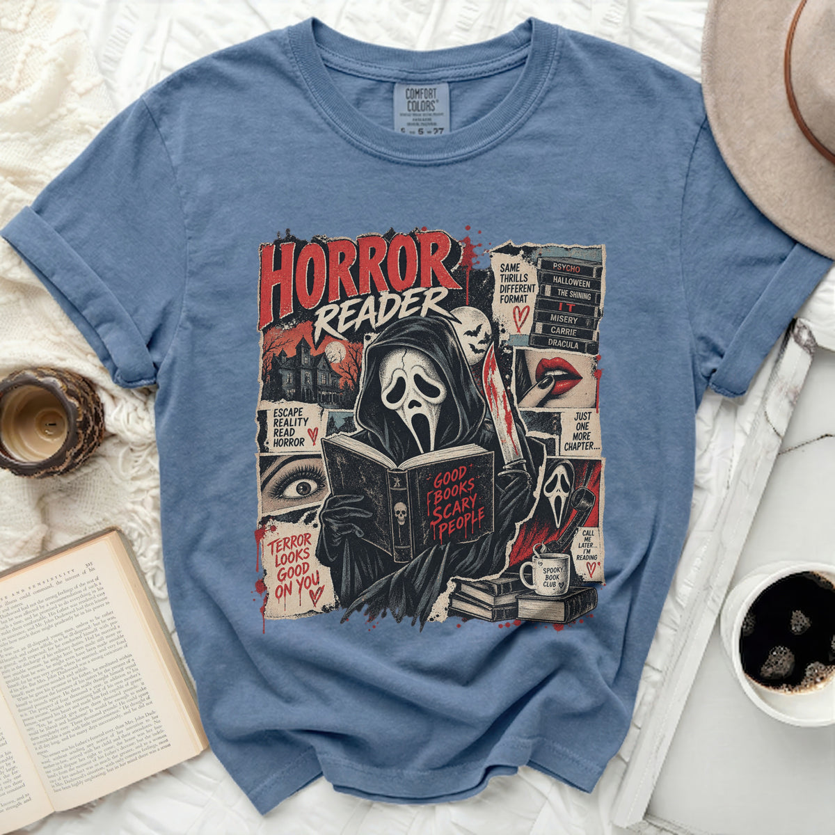 Blue t-shirt with a horror-themed graphic featuring a ghost reading a book titled "Good Books Scary People".