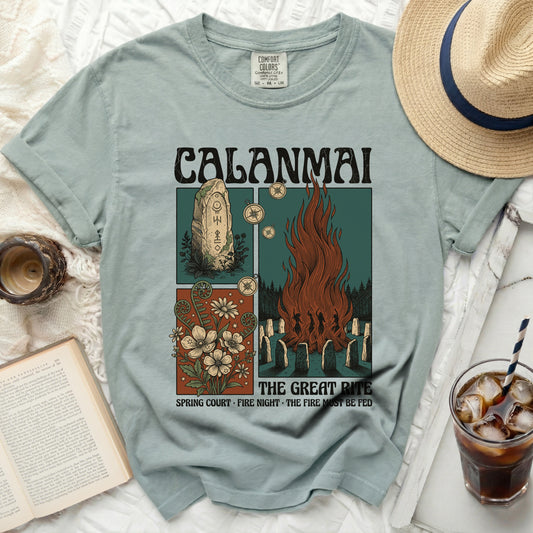 Calanmai t-shirt with graphics of a standing stone, flowers, and a bonfire ritual.