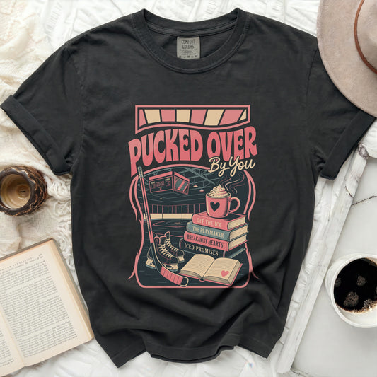 Dark t-shirt with "Pucked Over By You" hockey graphic and text.