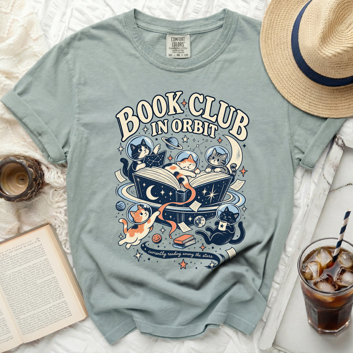 T-shirt with cats in space reading a book and "Book Club In Orbit" text.