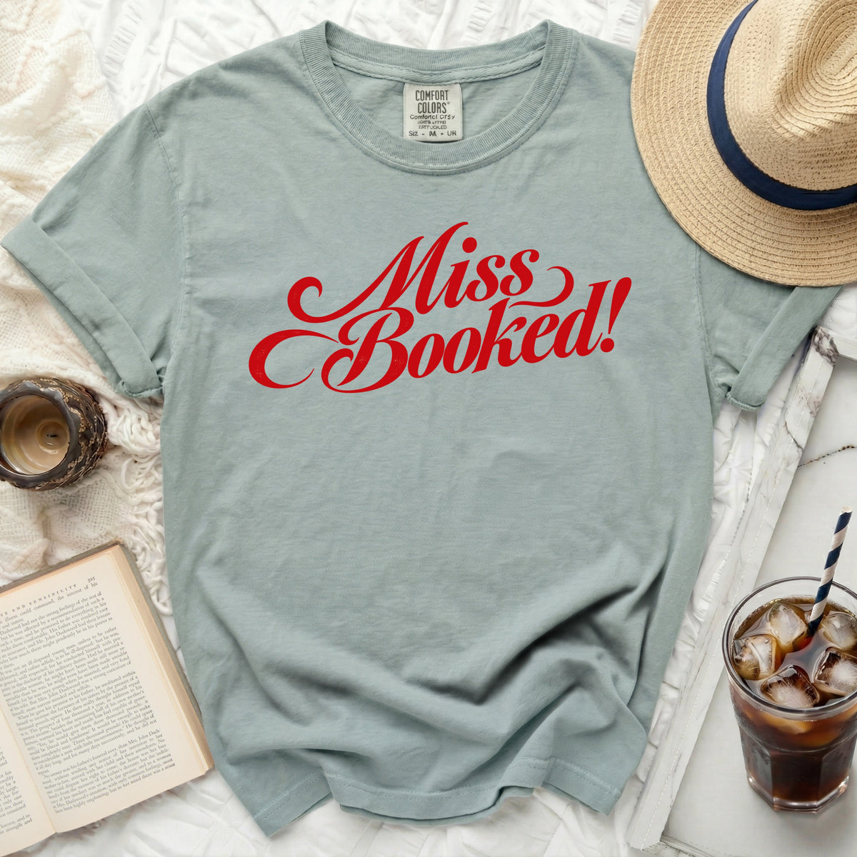 Light blue t-shirt with red "Miss Booked!" graphic and Comfort Colors tag.