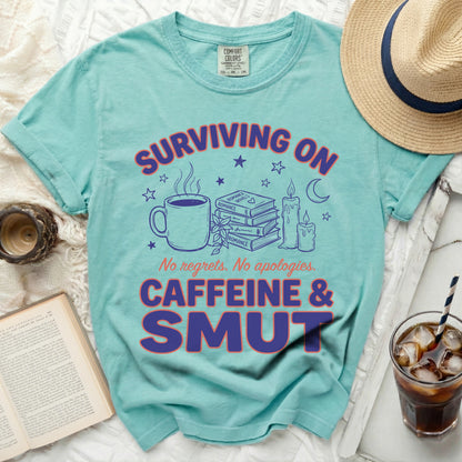 Aquatic t-shirt with text "Surviving on Caffeine & Smut."