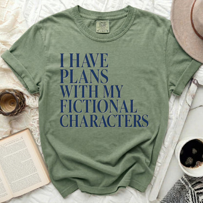 Green t-shirt with navy blue text reading "I HAVE PLANS WITH MY FICTIONAL CHARACTERS".