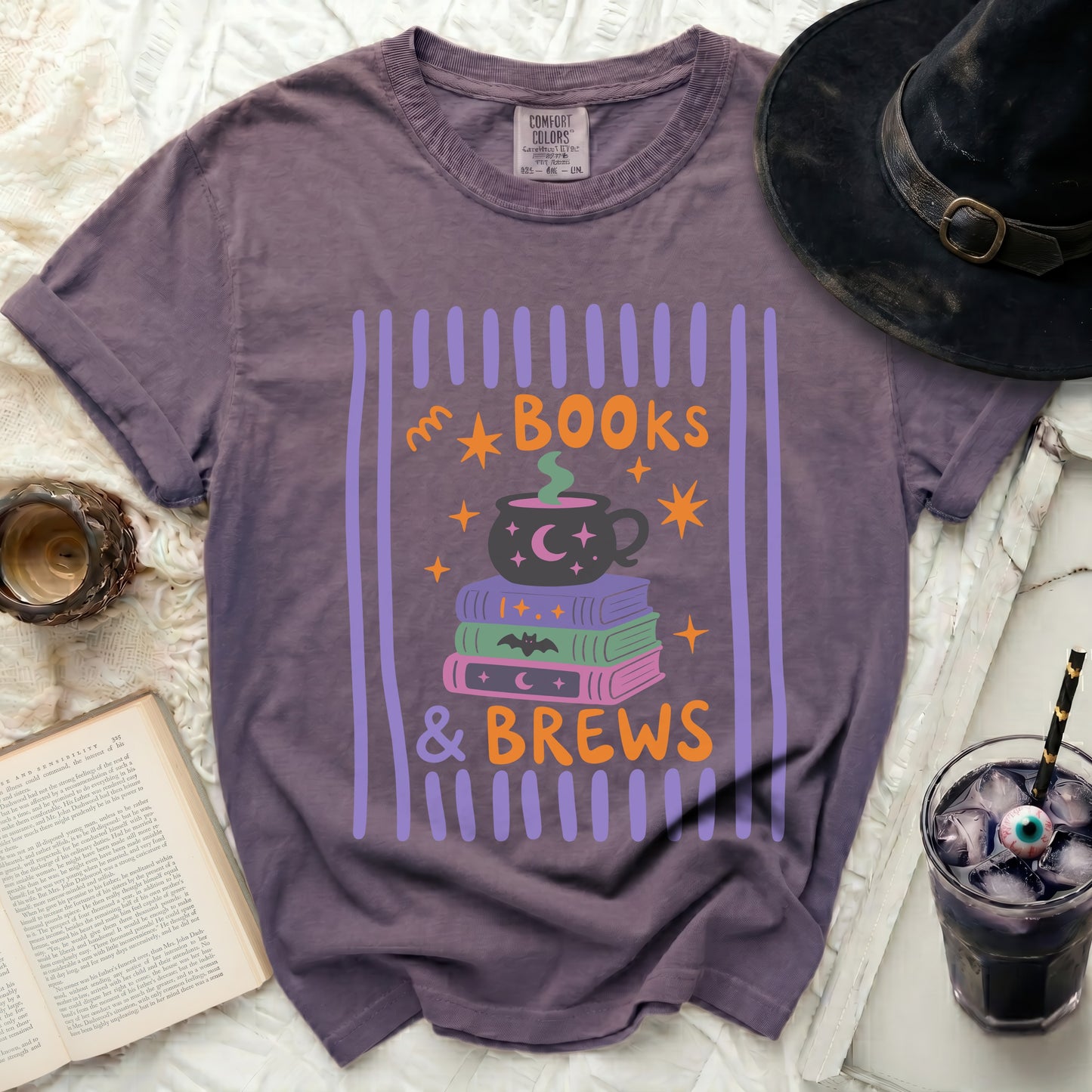 Purple t-shirt with "Books & Brews" Halloween graphic.