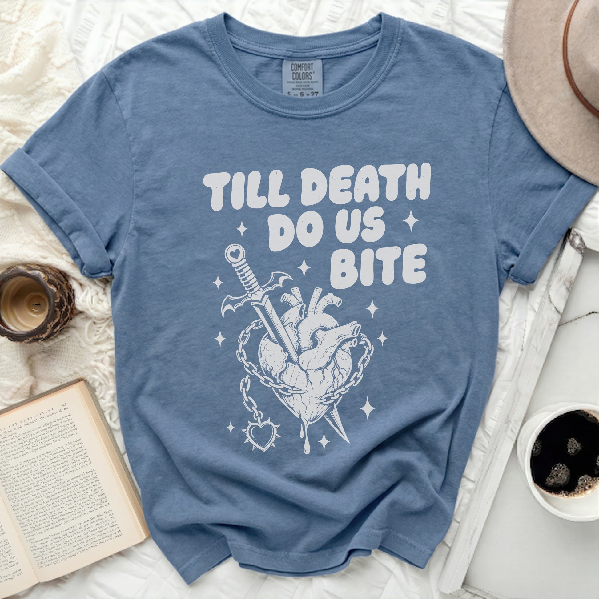 Blue t-shirt with "TILL DEATH DO US BITE" and heart-sword graphic.