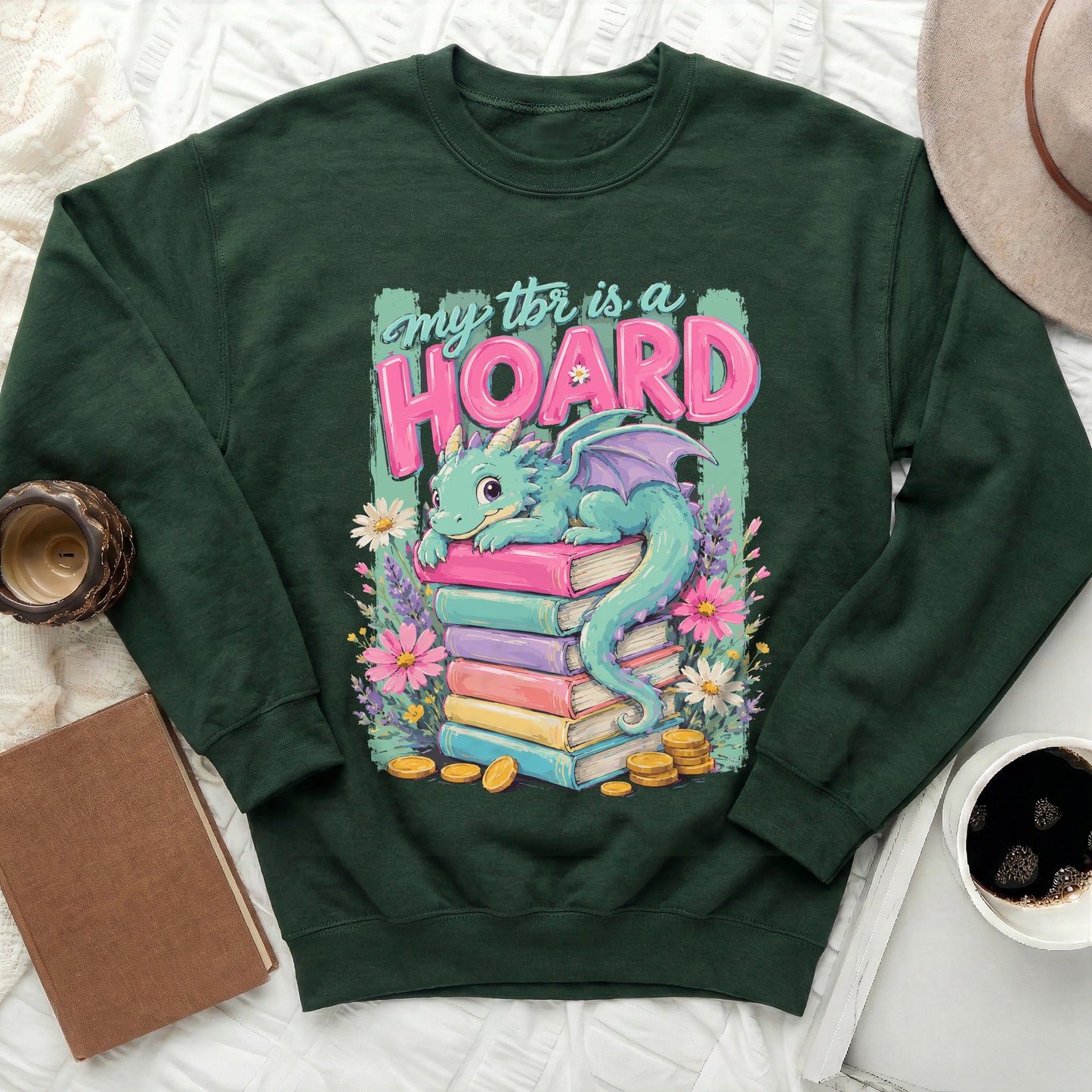 Dark green sweatshirt with a graphic of a dragon on a stack of books.