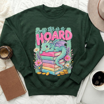Dark green sweatshirt with a graphic of a dragon on a stack of books.