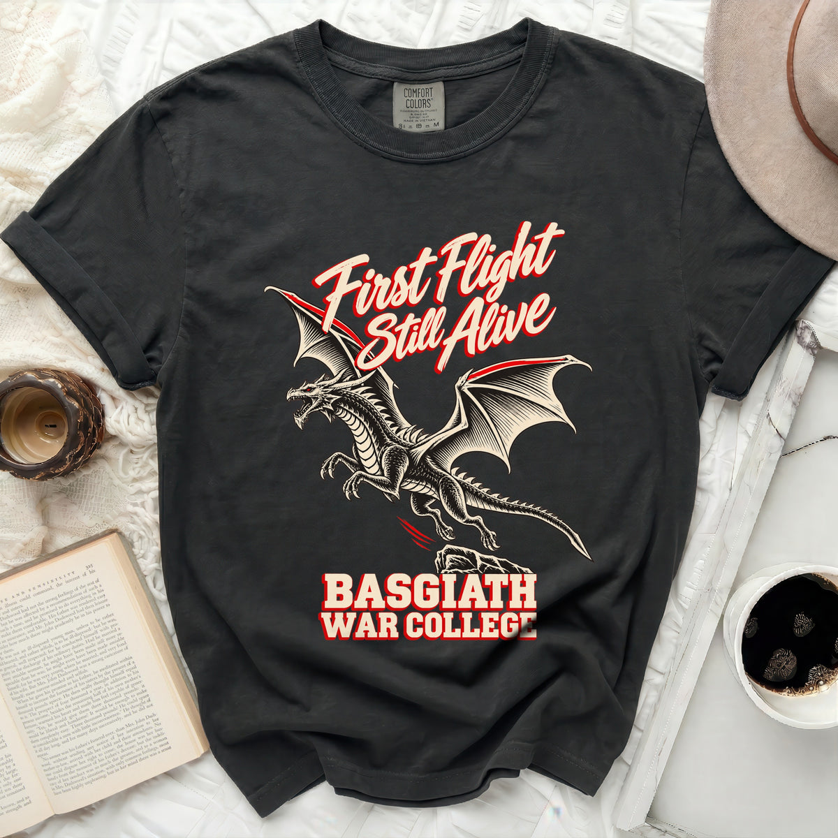 Black t-shirt with a dragon and text "First Flight Still Alive Basgiath War College".