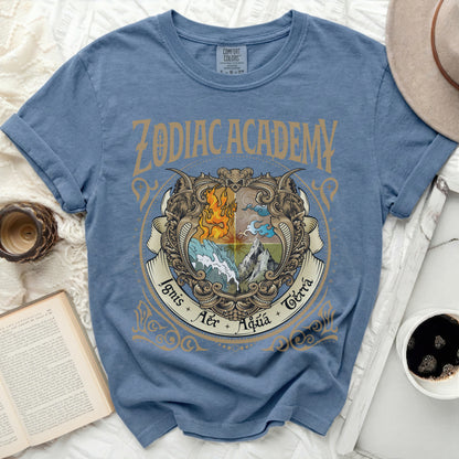 A blue Zodiac Academy graphic t-shirt with a vintage crest depicting fire, water, air, and earth elements.