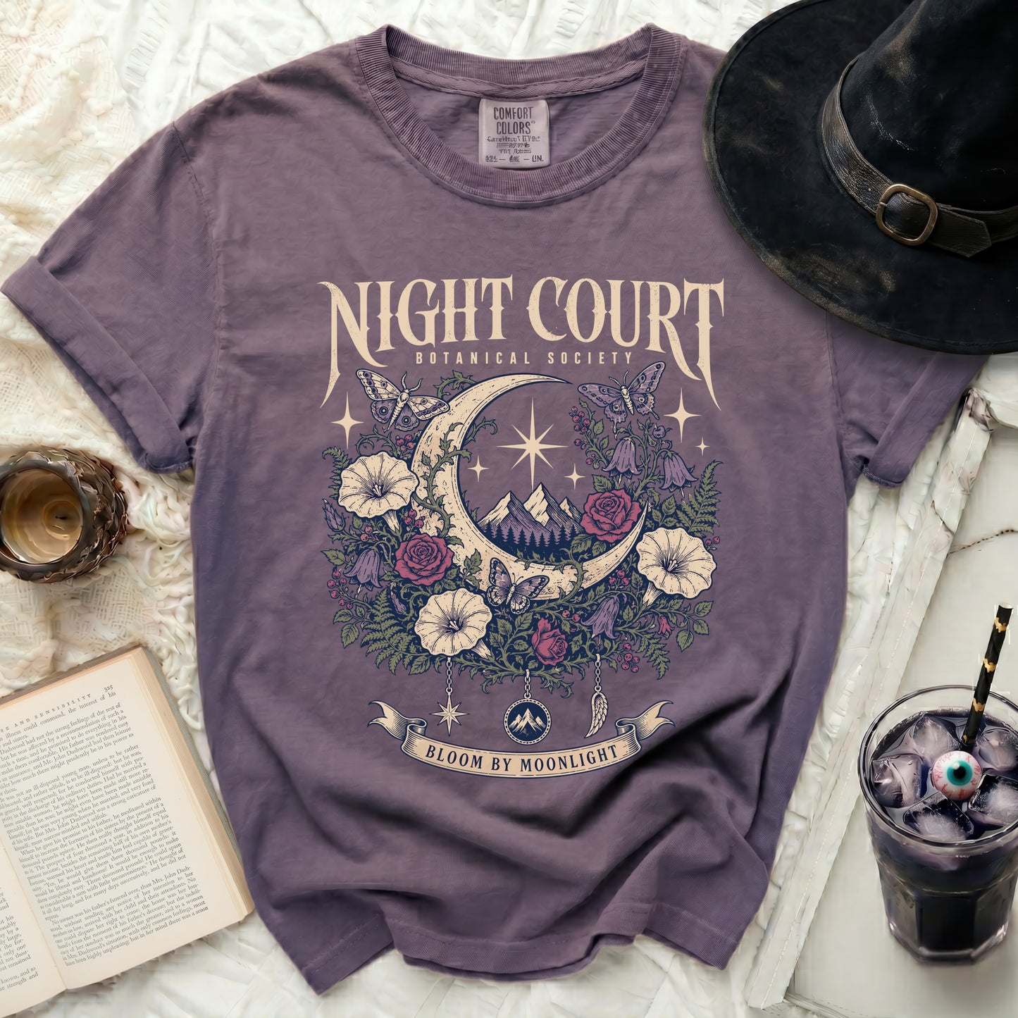 Purple t-shirt with "Night Court Botanical Society" and "Bloom by Moonlight" graphic.