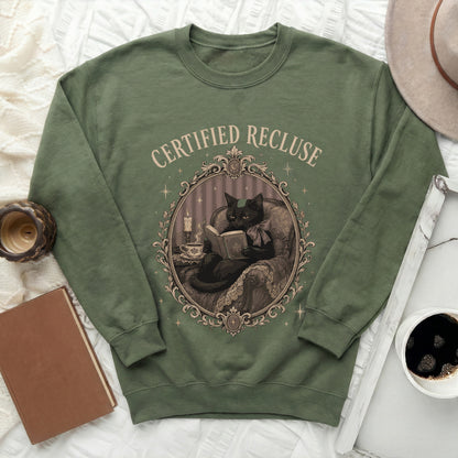 Green sweatshirt with "Certified Recluse" text and illustration of a cat reading.